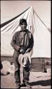 Elwood Dennis standing in front of a tent