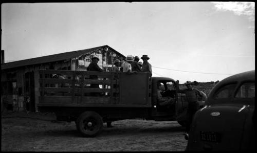 Hopi men riding in a truck