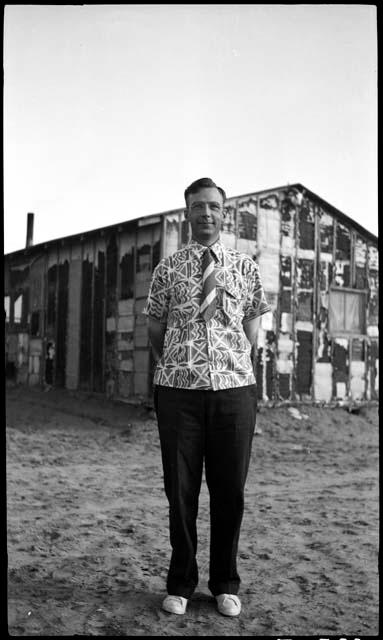 Watson Smith in printed shirt and striped tie.