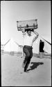 Volney Jones, balancing a trunk on his head.