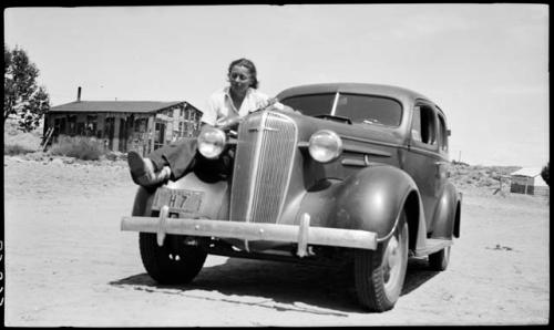 Penny Davis sitting on Wat's car.