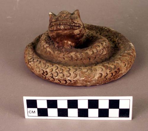 CAST of snake effigy, coiled, engraved scales