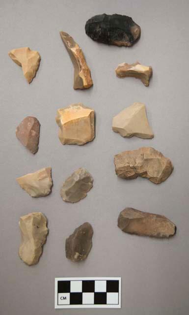 Flint scrapers, including black, tan, grey, cream, pink and brown colored stone, some contain cortex