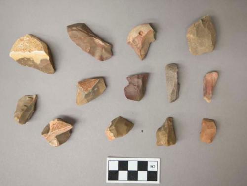 Flint scrapers, including tan, grey, brown, pink and cream colored stone, some contain cortex