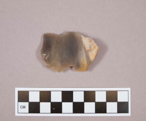 Notched flint flake with cortex; tan colored stone