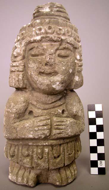 Ground stone sculpture, carved human figure with geometric designs