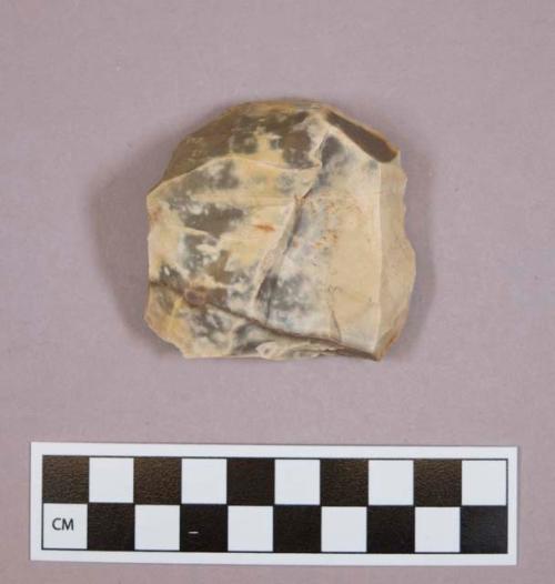 Flint core; disc-shaped; cream colored stone