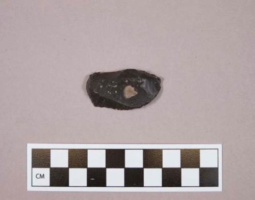 Flint endscraper on blade; black colored stone