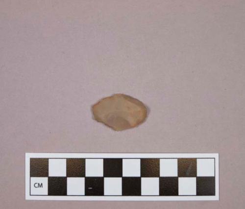 Flint endscraper on tan colored stone