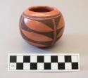 Black-on-red ceramic bowl: geometric motif