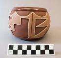 Red-on-buff carved ceramic bowl: geometric motif