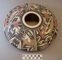 Polychrome-on-white bowl: complex parrot and geometric motifs