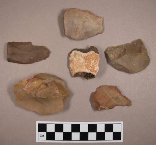 Flint scrapers, including tan, brown, grey and rust colored stone, some contain cortex