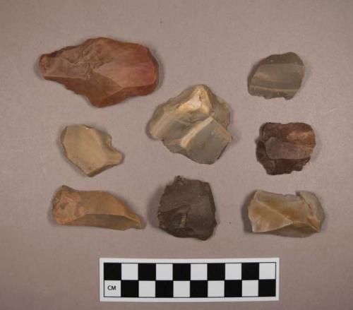 Flint flakes and scrapers, including tan, grey, brown, cream and red colored stone