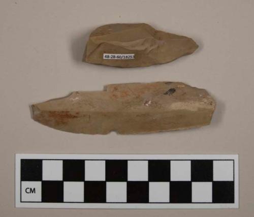 Flint flakes; one blade, one burin(?); gray-colored stone