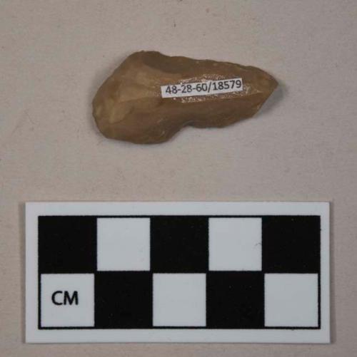 Flint flake; notched blade; tan-colored stone