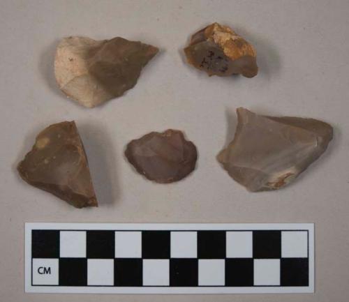 Flint flakes; pointed scrapers; three with cortex; variously colored stone