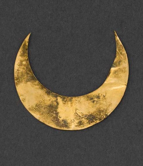 Gold crescent-shaped object