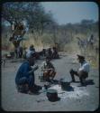 Expedition members and a group of people in camp