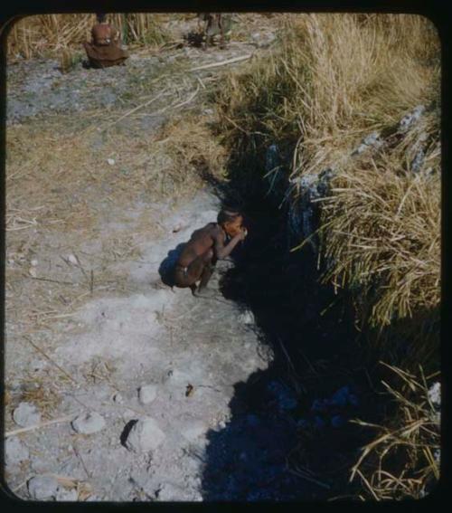 Man drinking at waterhole at Gura