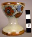 Ceramic egg cup.w/ floral & incised designs, blue & brown on grey