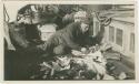Arctic Voyage of Schooner Polar Bear - Man laying on deck sewing pelts