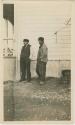 Arctic Voyage of Schooner Polar Bear - Two men outside building