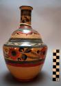 Shouldered bottle. tall, with cylindrical neck. geometric and floral designs