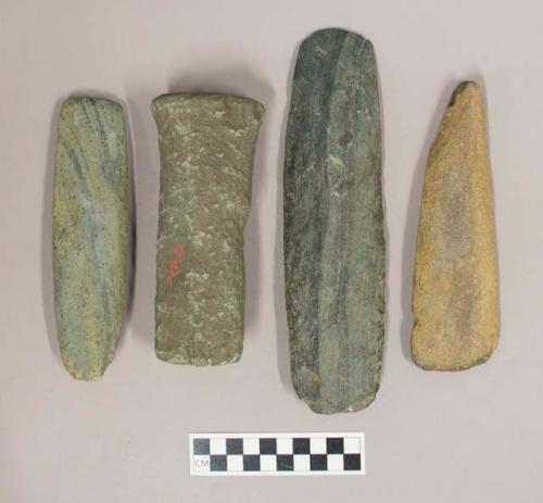 Ground stone, pestle with one end broken and one blunt end, and three adzes