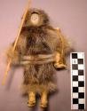 Doll - man in sealskin with leather leggings, leather pack on back, ivory spear.