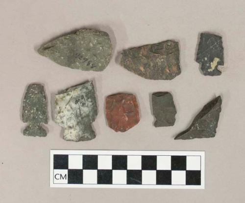 Chipped stone biface and projectile point fragments, including side-notched projectile points