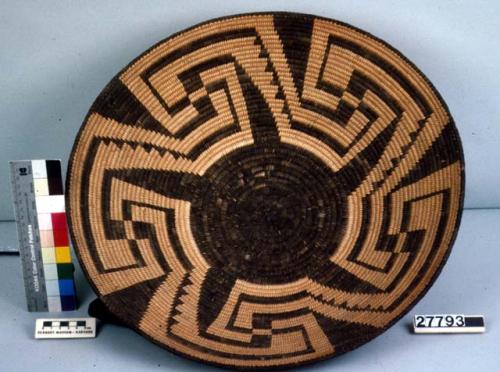 Large basketry bowl, coiled. Black center surrounded by black geometric designs