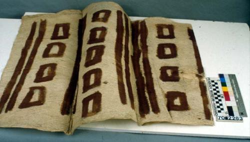 Light patterned woman's tapa cloth with brown stripes