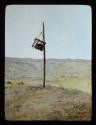 Lantern slide of cage on a pole, hand-colored