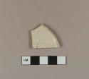 White salt glaze stoneware rim sherd; molded with dot diaper and basket pattern