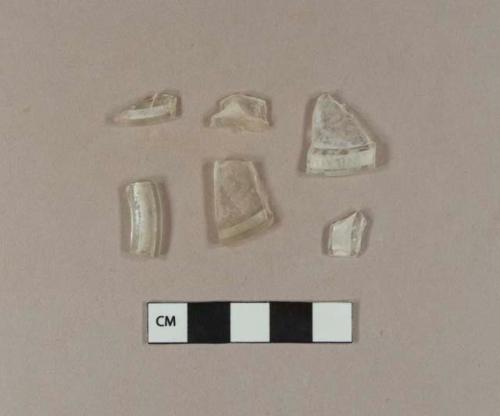 Colorless glass fragments with rolled rims, possible stemware base fragments