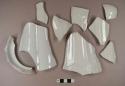 White ironstone vessel body and base fragments, white paste, molded decoration on exterior surface