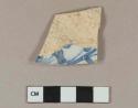 Blue on white handpainted tin glazed earthenware vessel body fragment, buff paste