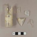 Three piece mold colorless glass vial or bottle; fragments crossmend, some have been mended with scotch tape