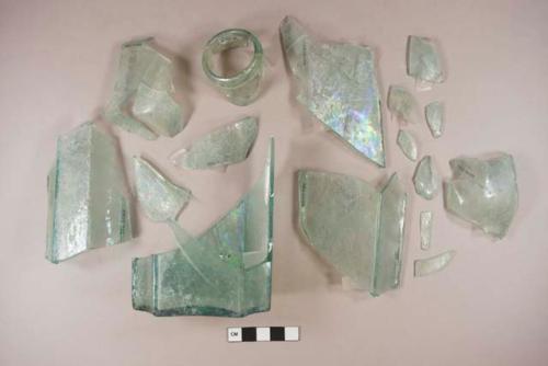 Aqua faceted glass bottle fragments; open pontil scar; folded finish; fragments crossmend, some mended with scotch tape