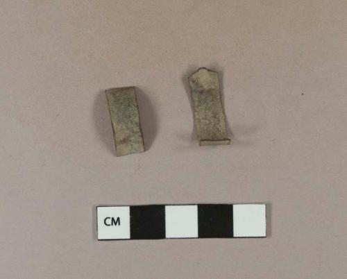 Copper alloy strip fragments; two fragments crossmend