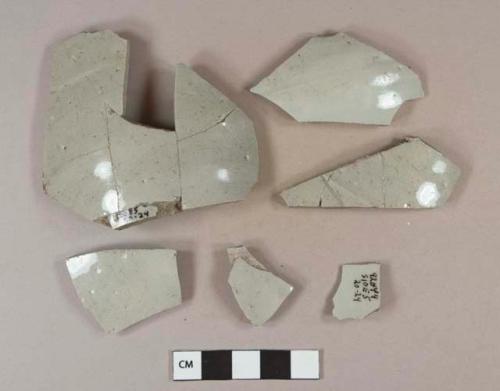 Undecorated gray stoneware body sherds; some sherds crossmended with glue