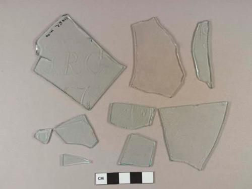 Light aqua flat glass fragments, 6 with intentional scratched etchings, 1 fragment with letters "JRC" scratched (see Gerry 1988)