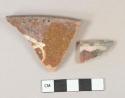Brown and yellow slip decorated redware vessel rim fragments