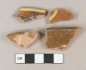 Yellow and brown slip decorated redware vessel rim fragments