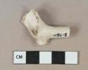 White kaolin pipe bowl fragment with part of stem, stem with 5/64" bore diameter. partial stamp on bowl, molding on foot, trace of removed ink lettering.