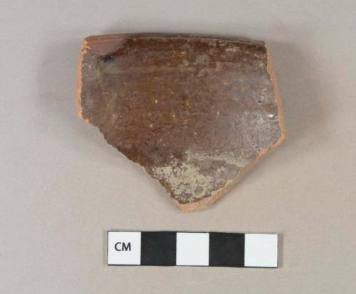 Dark brown lead glazed redware vessel rim fragment