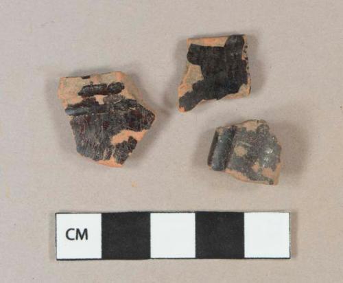 Dark brown lead glazed redware vessel rim fragments