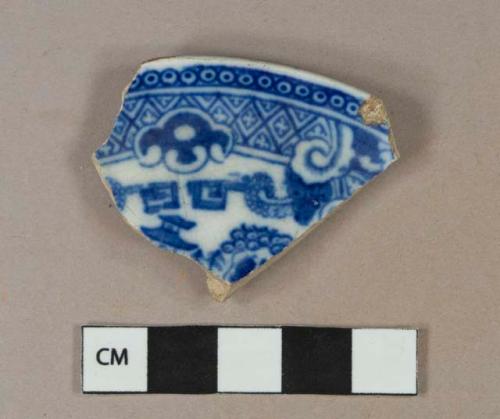 Blue on white handpainted pearlware vessel rim fragment, likely saucer, white paste