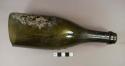 Dark olive green glass round bottle, likely wine or champagne, champagne finish